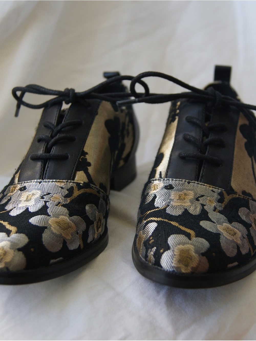 Nine West black and gold floral oxford shoes.